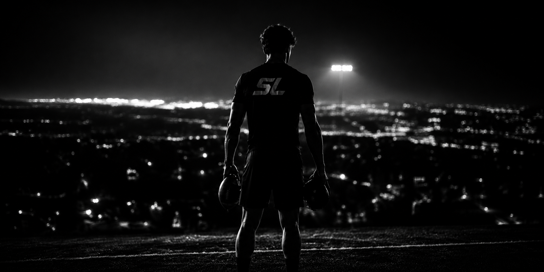 Athlete overlooking city at night